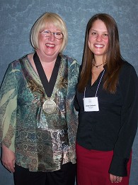 Candy Wallace (l.) receives the Foodservice Educator Network International's 2010 Medallion of Excellence from Lacey Griebeler, managing editor of Chef Educator Today